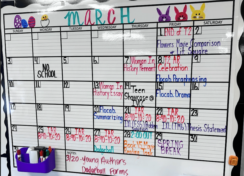 Whiteboard calendar for March filled in with colors.